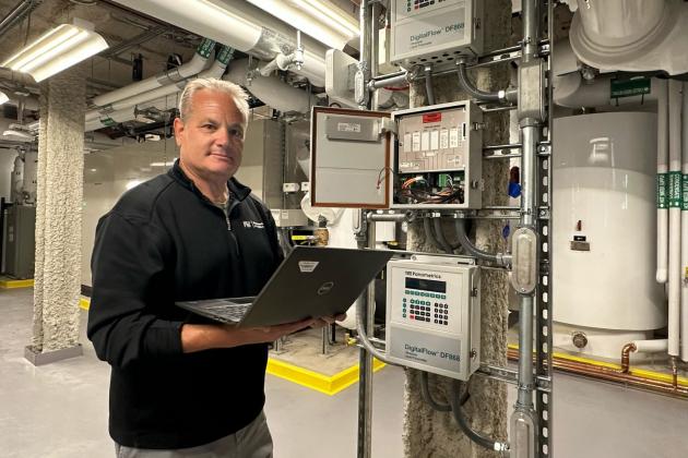 Fran Selvaggio, senior building management systems engineer in the MIT Department of Facilities, stands in the newly renovated Met Warehouse, where an innovative heat-recovery system captures heat rejected from the campus cooling system and uses electric heat pumps to generate heat for the building. 